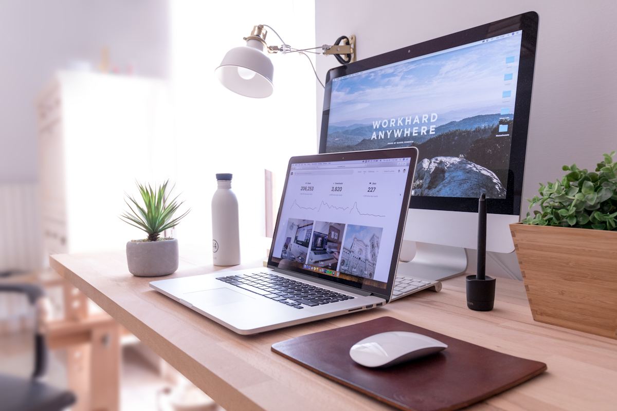 Sunlit desk with a laptop and a cup